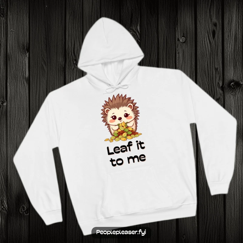 Funny hoodie featuring a proud hedgehog character showing off a neatly organized pile of leaves, offering warmth and organized satisfaction.