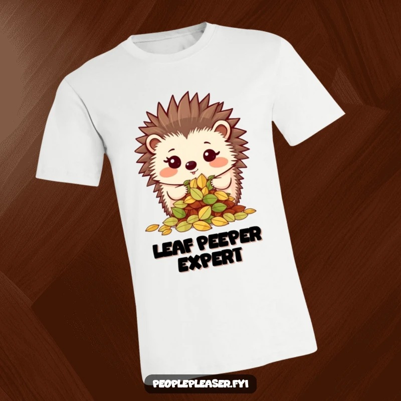 Funny t-shirt depicting a proud hedgehog character showing off a neatly organized pile of leaves, exuding accomplishment and neatness.